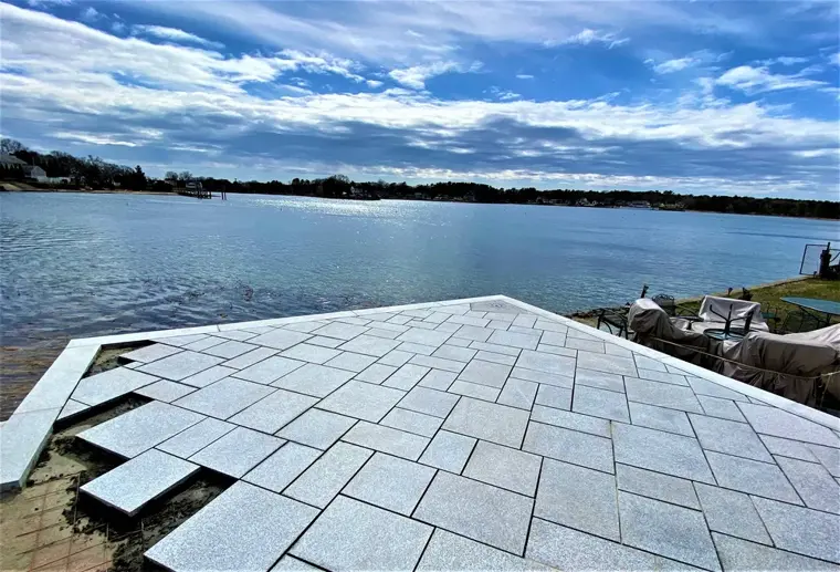 Bluestone patio being laid at the water