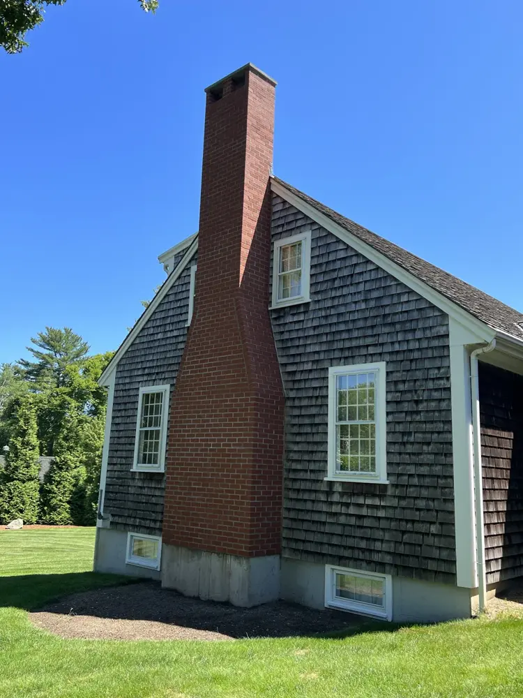 Brick chimney on a shingled cape