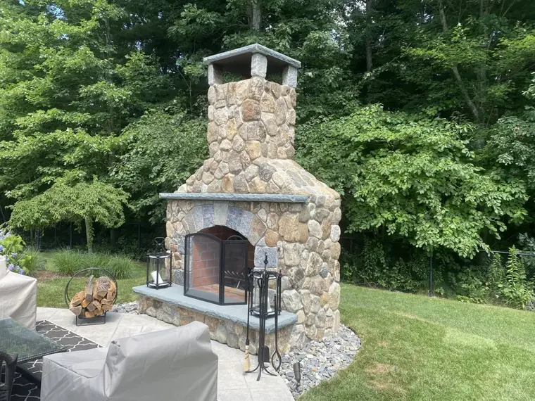 Outdoor fieldstone fireplace and chimney