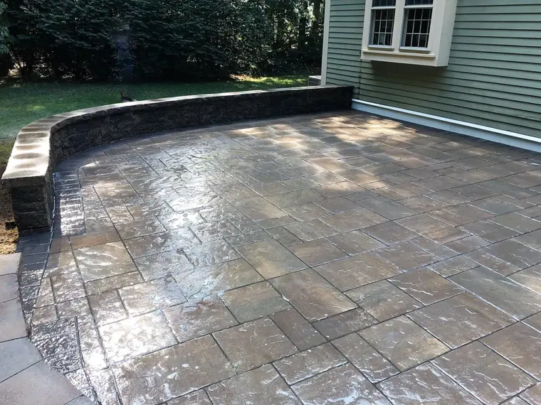 Textured paver patio with stone wall